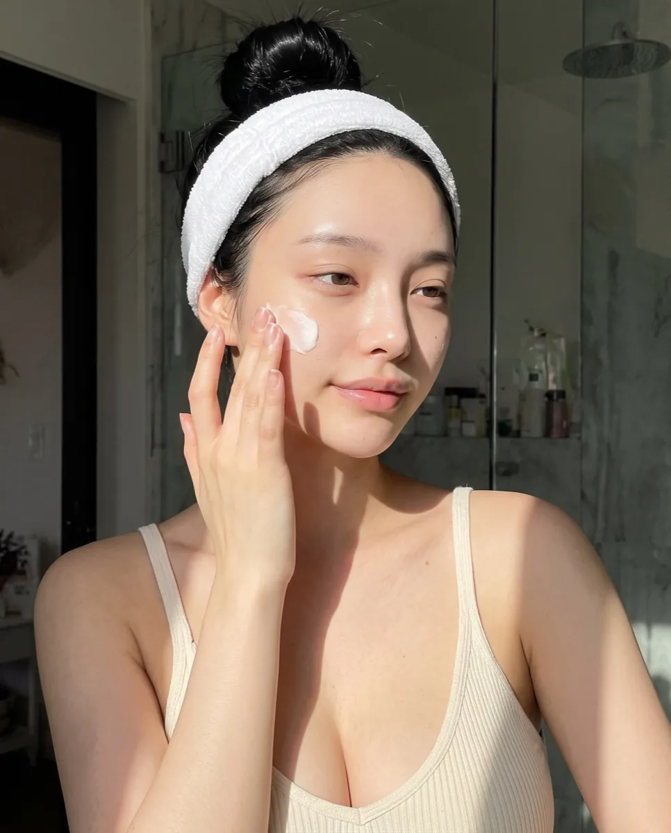 Ayaa applying skincare at her bathroom shelf